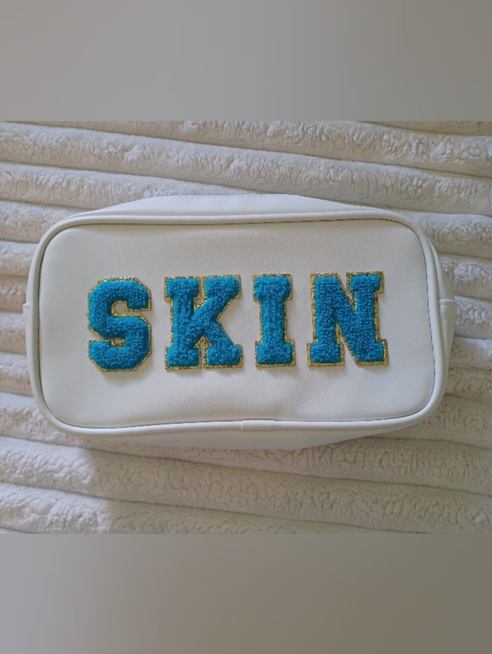 Neutrogena White Makeup Bag with Blue 'SKIN' Chenille Patch